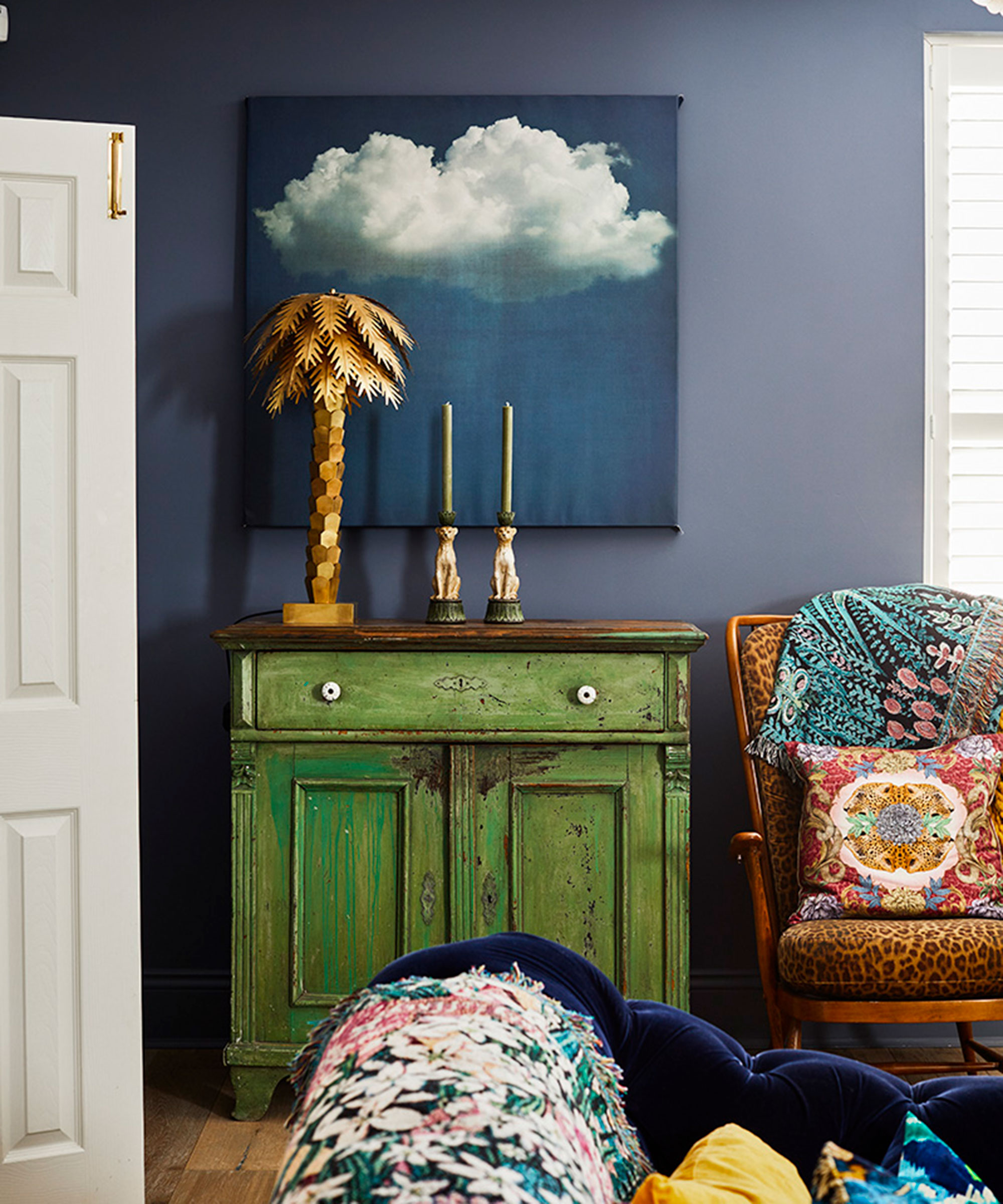 Blue living room with green painted dresser and eclectic accessories