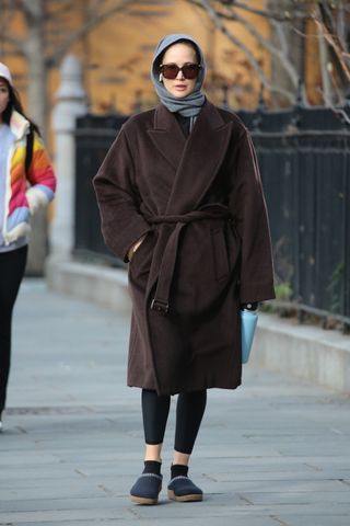 Jennifer Lawrence wearing a robe coat and slippers to the gym.