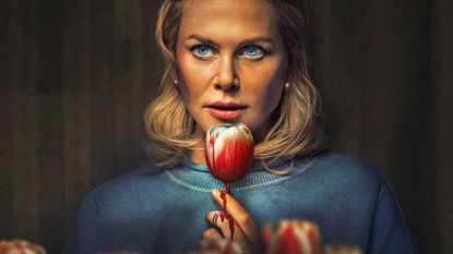 Nicole Kidman holds a candy apple that is dripping blood