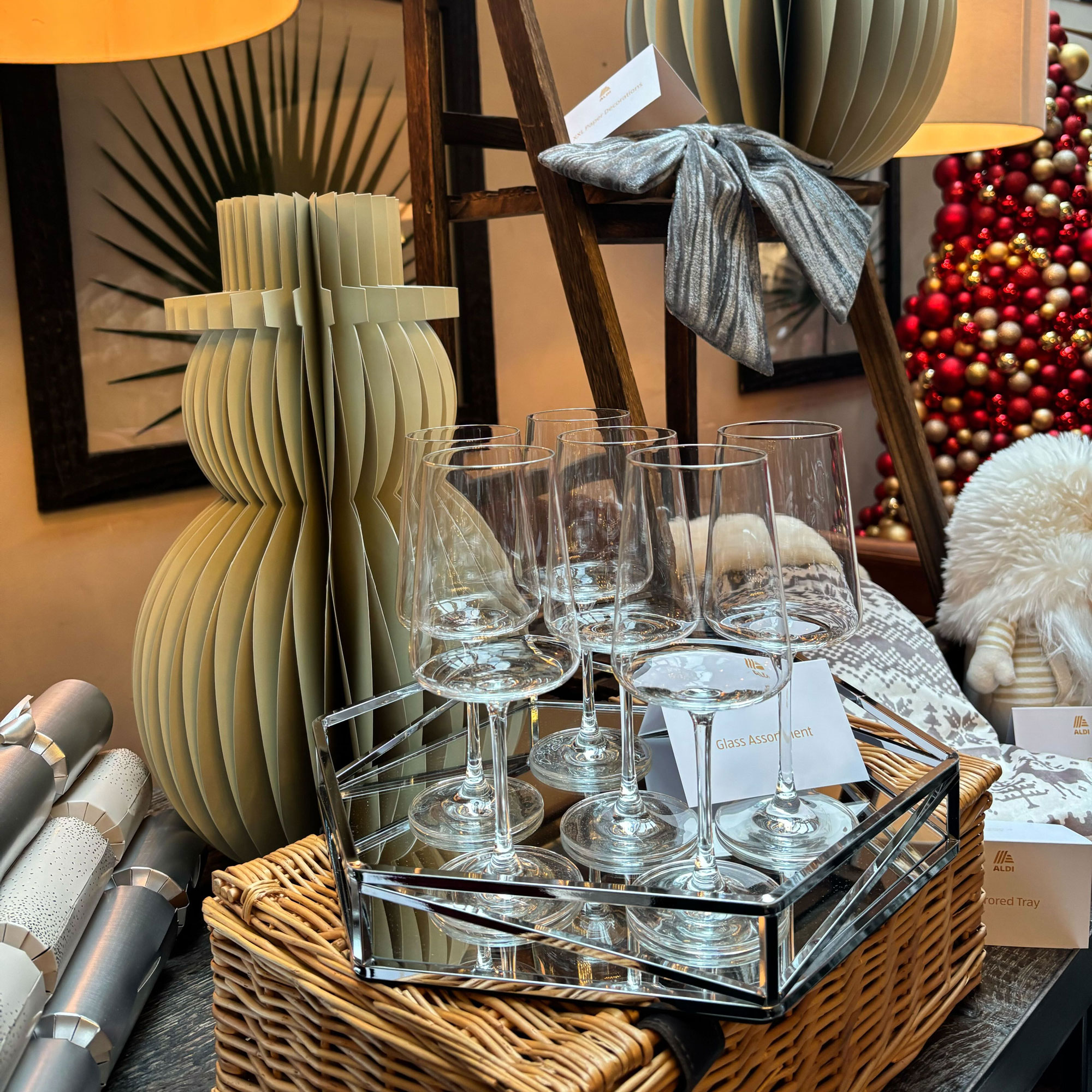 Wine glass on mirror tray with paper snowman