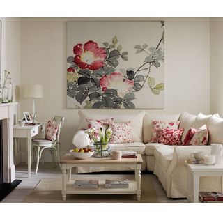 living room with white sofa set with dotted red cushions