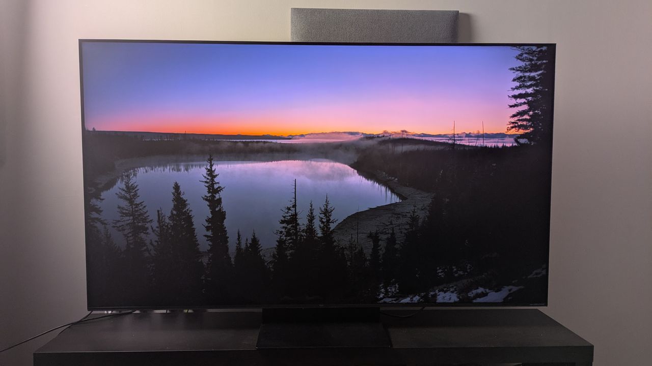 TCL C7K with sunset over lake on screen