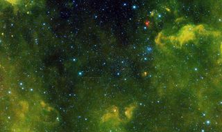 Image of more than 100 asteroids captured by NASA's Wide-field Infrared Survey Explorer, or WISE, during its primary all-sky survey in 2014. Clouds of gas and dust surround the region, visible only in infrared light. More than 2,500 stars are also in this view.