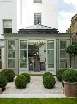 Perfectly shaped hedges and extension with plenty of windows an natural light for outdoorsy feeling dining