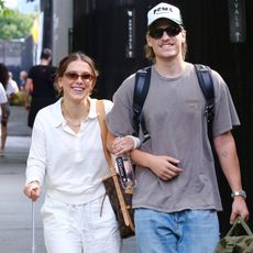 Millie Bobby Brown smiles at the camera while arm-in-arm with Jake Bongiovi 