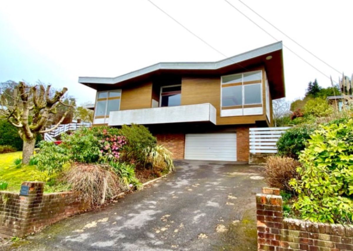 View from the road of the zigzag shaped roof of this 1960s self build home