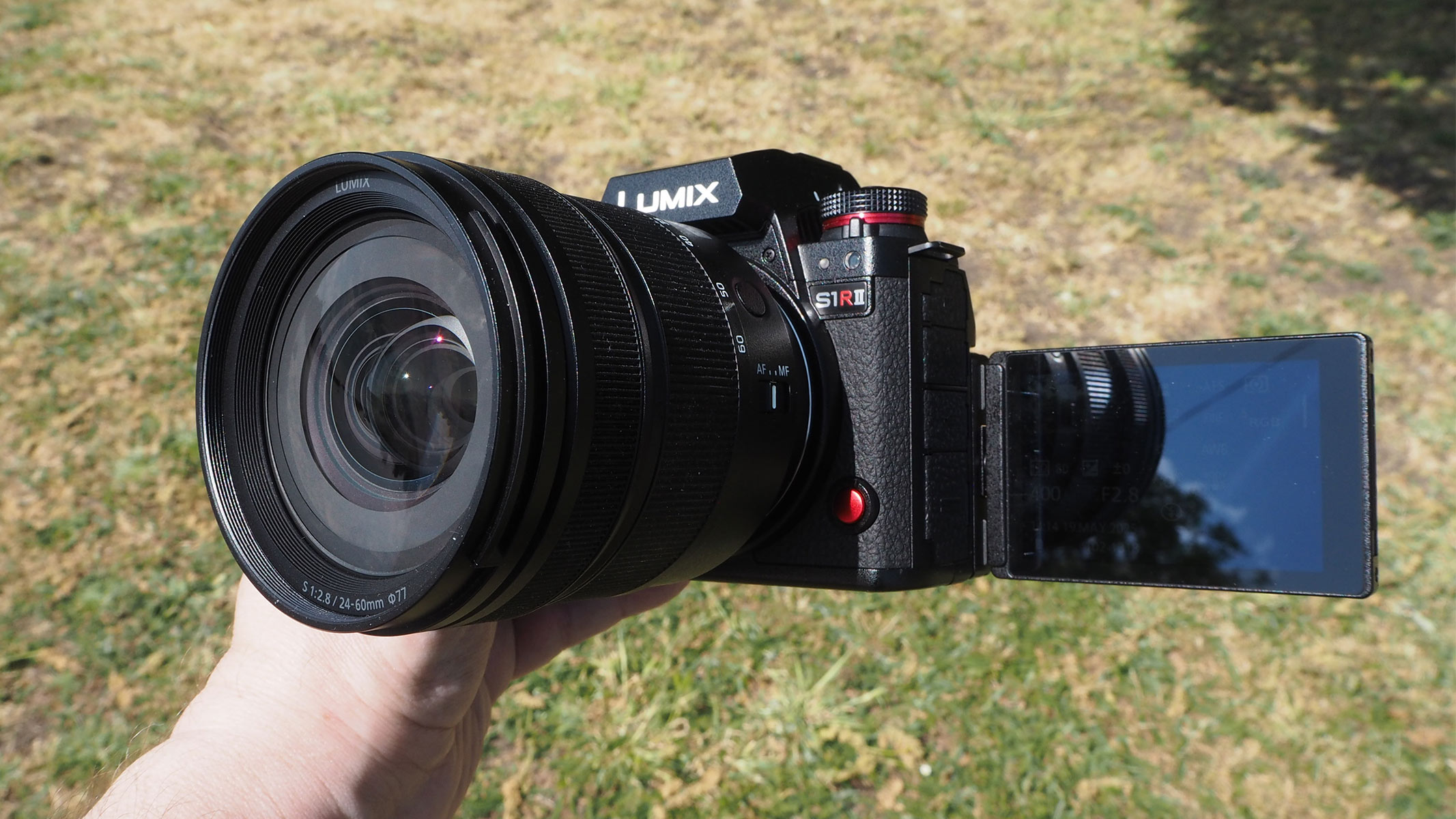 The Panasonic Lumix S1R II being held by our reviewer with the screen extended.
