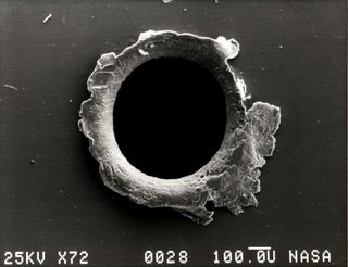 The hole created when a piece of orbital debris hit the Solar Maximum Mission satellite, or SolarMax.