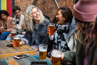 group of friends drinking in a pub with substantial meal