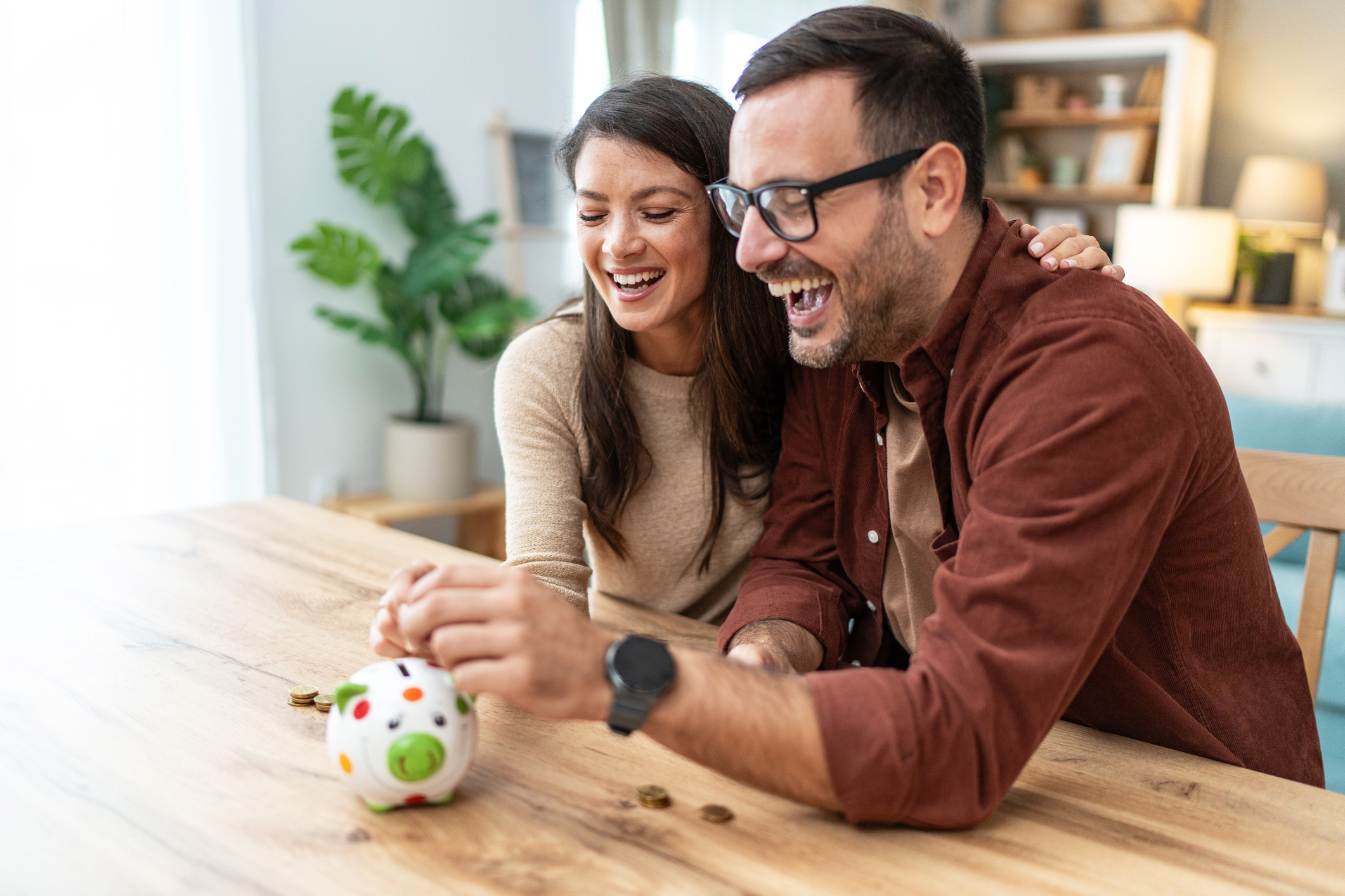 a couple happily saving money