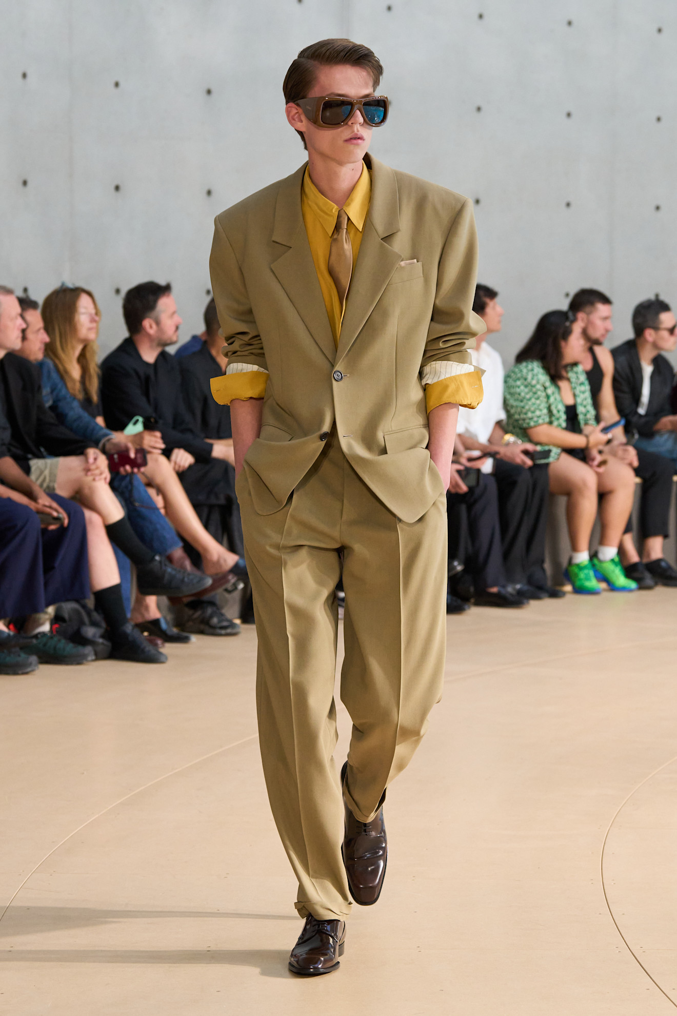 A model wore Connor Storrie's suit on the Saint Laurent Spring 2026 Men's runway
