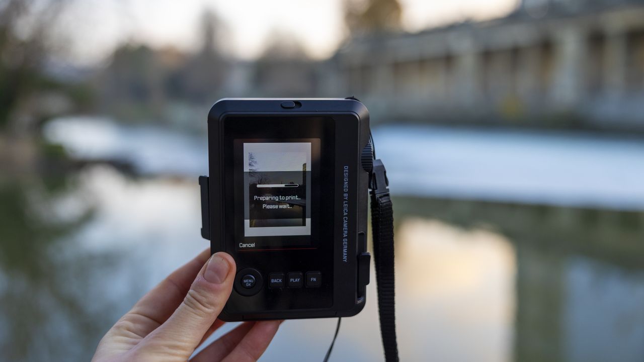 The Leica Sofort 2 preparing to print a wintry landscape scene