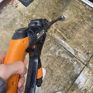 using the Worx Hydroshot pressure washer on a patio