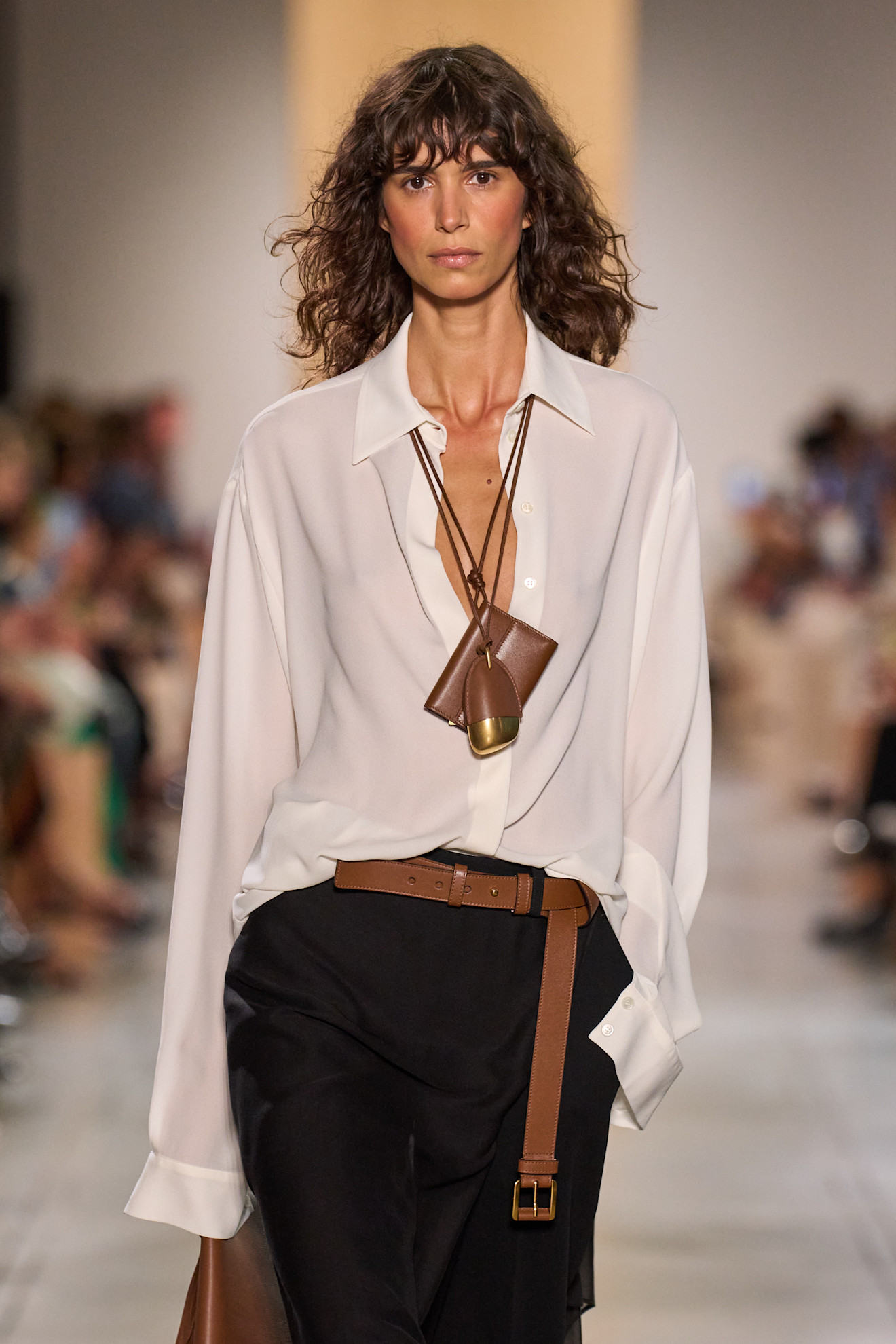 A Michael Kors model wearing a wallet necklace