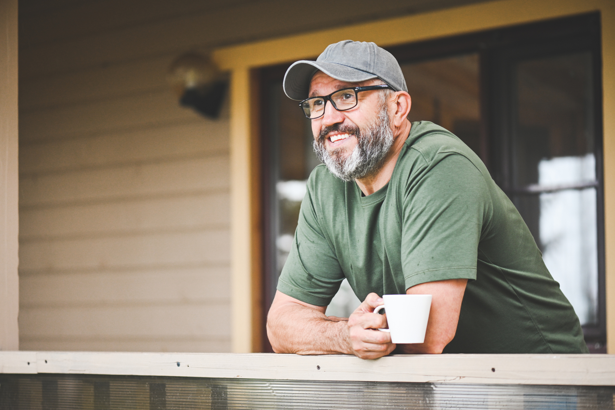 Older man relaxing on his porch.