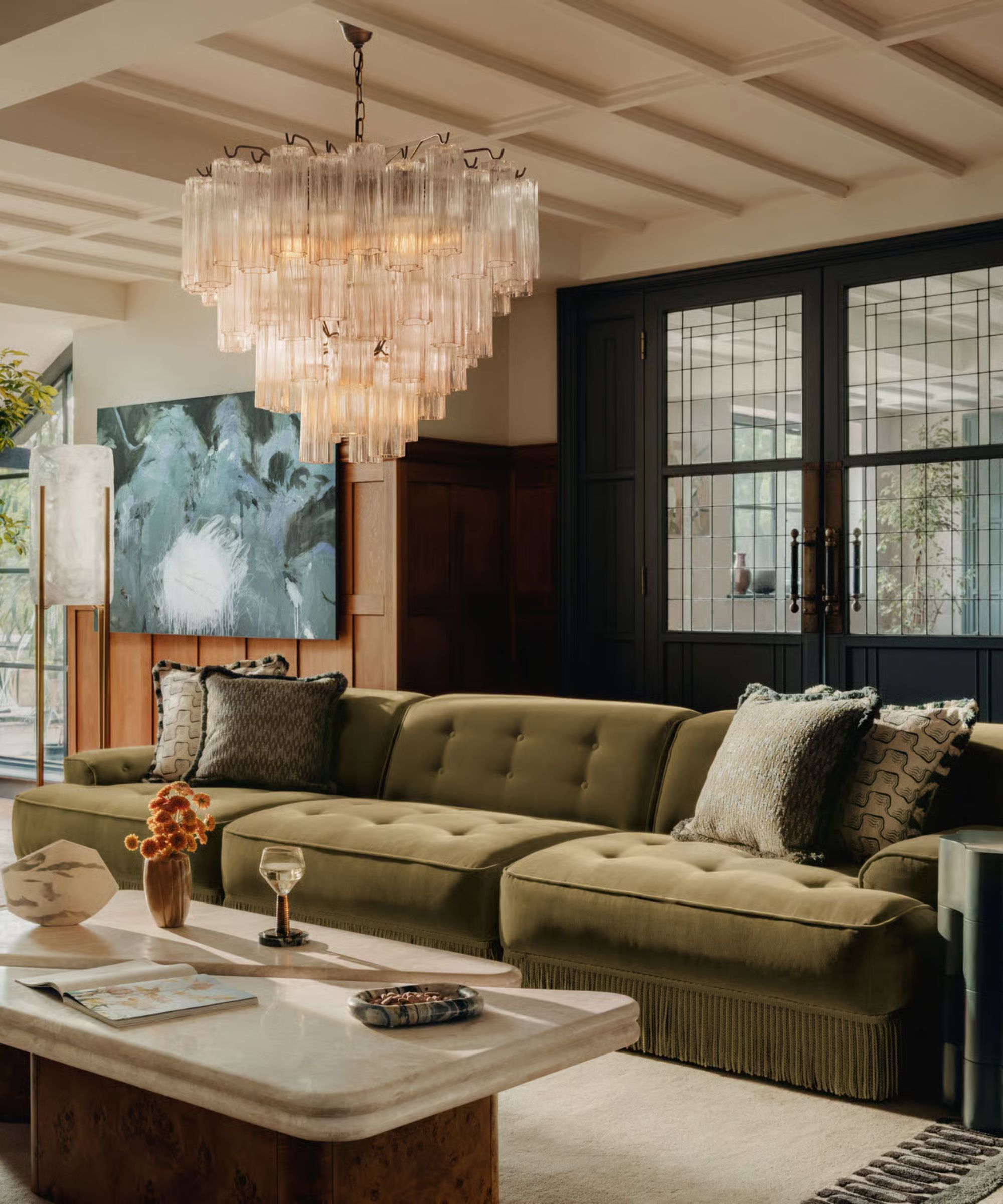 A large retro green sofa in a '70s style, mid-century modern sitting room scheme
