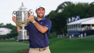Scottie Scheffler raises the trophy aloft after winning the PGA Championship 2025