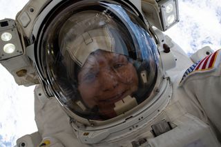 nasa astronaut anne mcclain in a spacesuit smiling