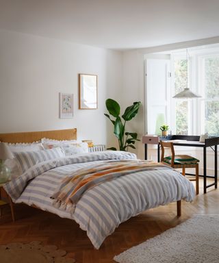 bedroom office with accent lighting over a desk and bedside lamps - Habitat