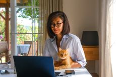 Asian woman working on laptop computer from home