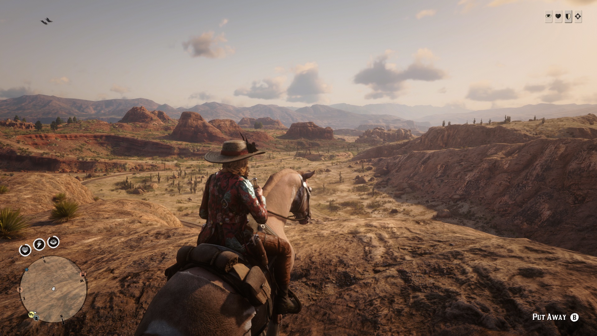 Red Dead Online - A player on a horse looks into a desert vista at sunset