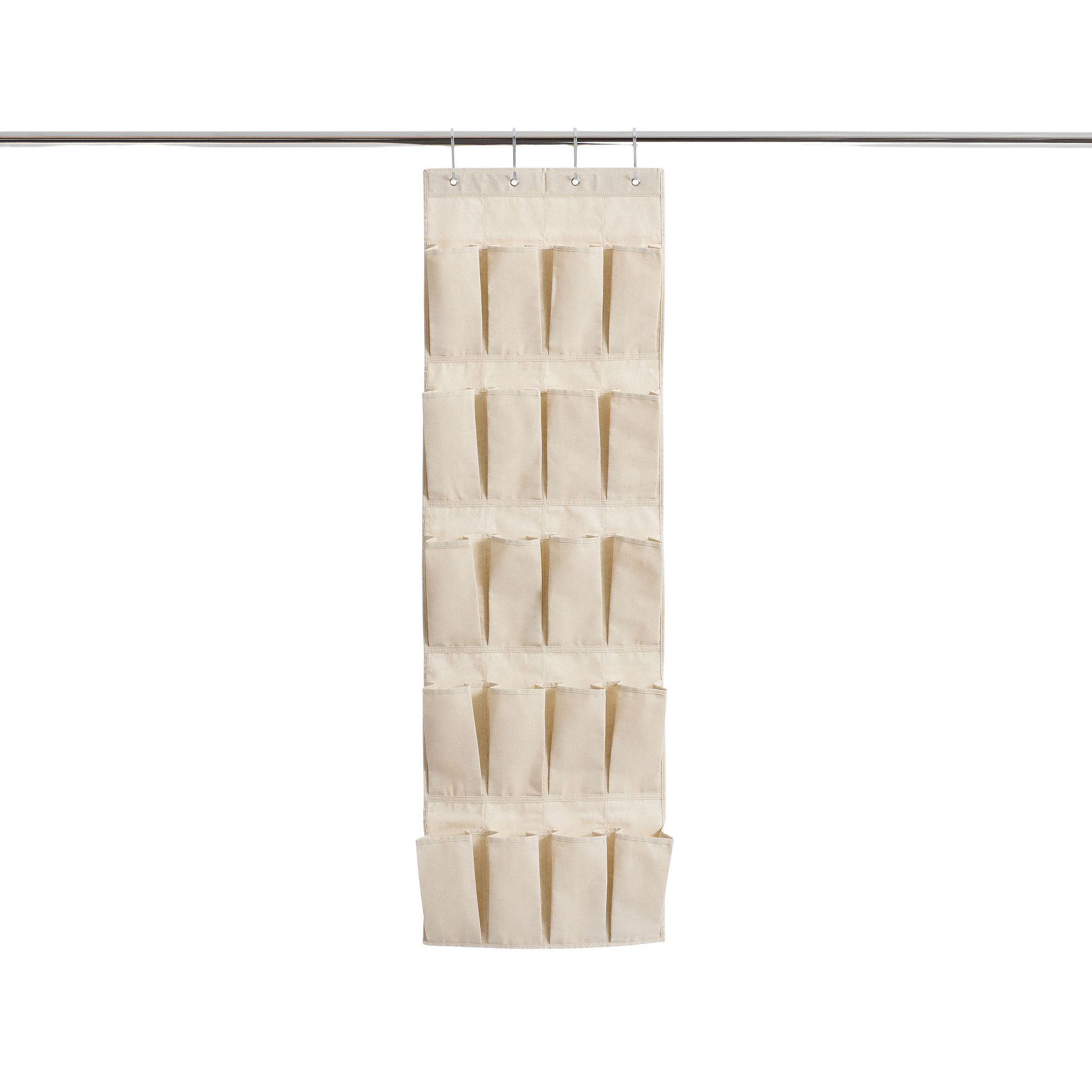 A linen shoe organizer hanging on a silver rail
