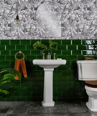 white pedestal sink against dark green metro wall tiles