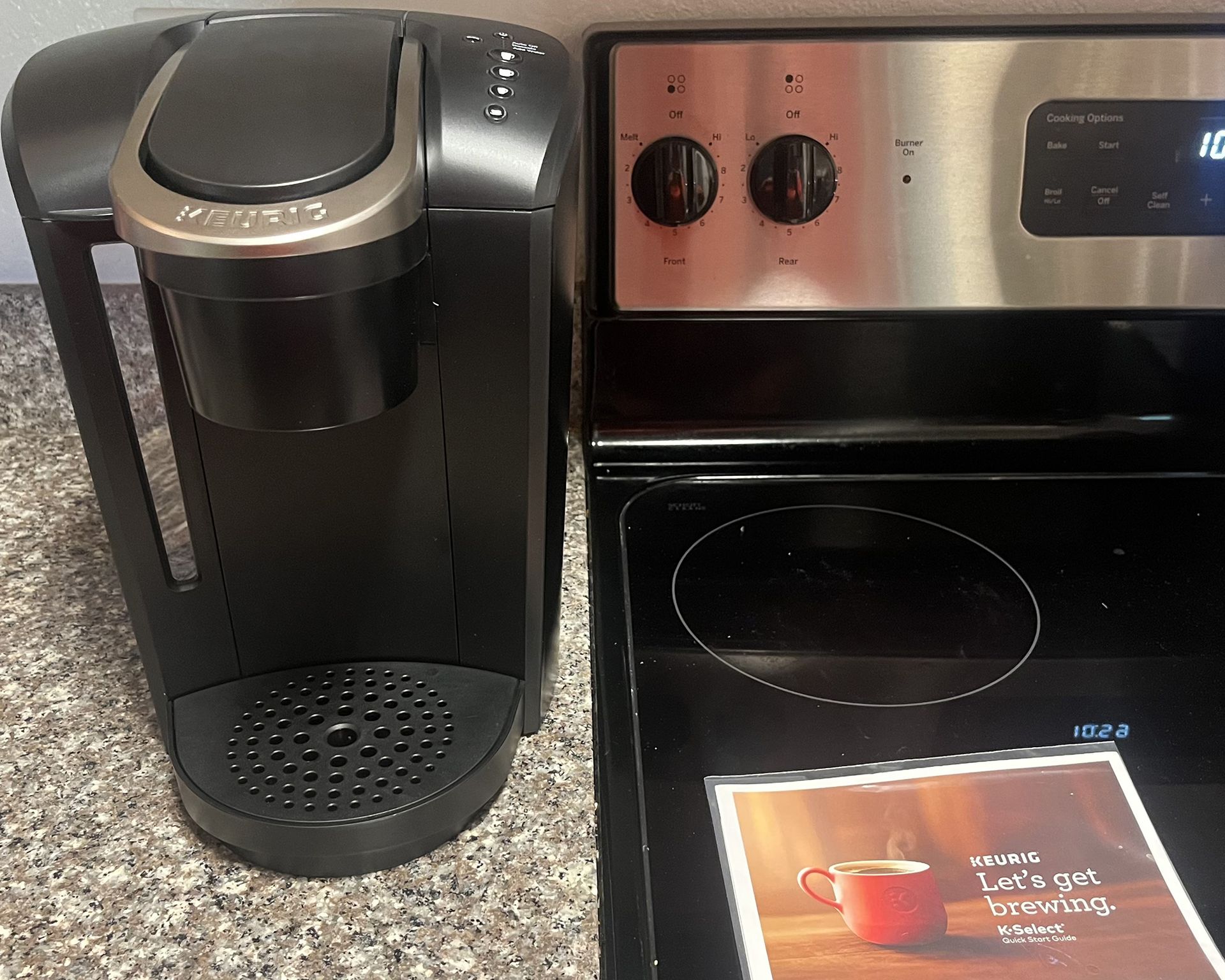 Keurig K-Select on granit look countertop with instruction manual