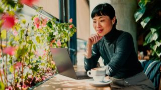 Dell XPS 14 being used on a desk in front of a window