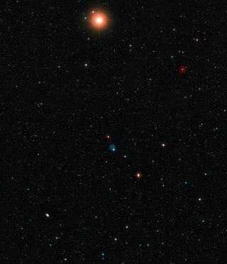 This wide-field view shows the sky around the planetary nebula Abell 33, which appears as the ghostly blue circle near the centre of the picture. Image released April 9, 2014.