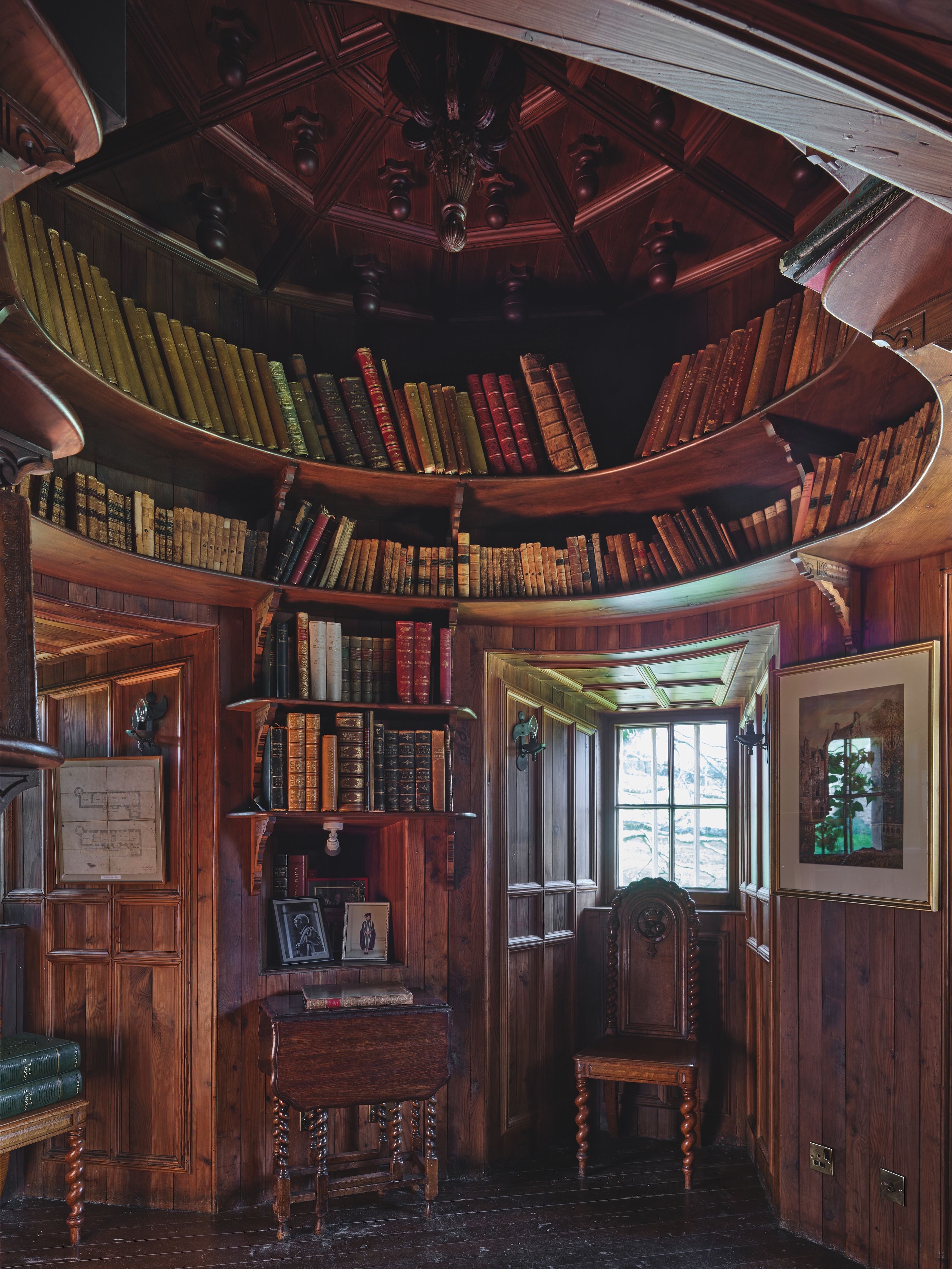 Library shelves and antique furniture in a turret tower