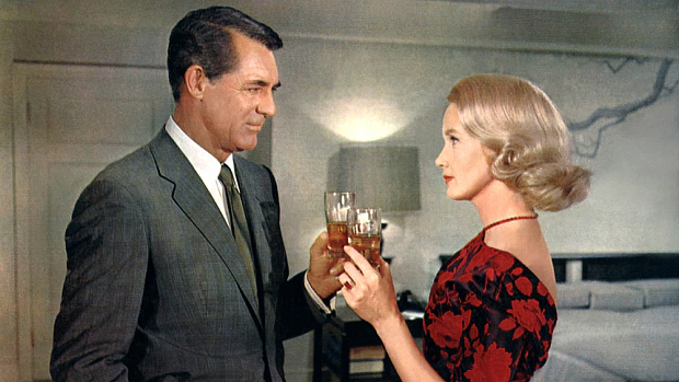Cary Grant sharing a drink.