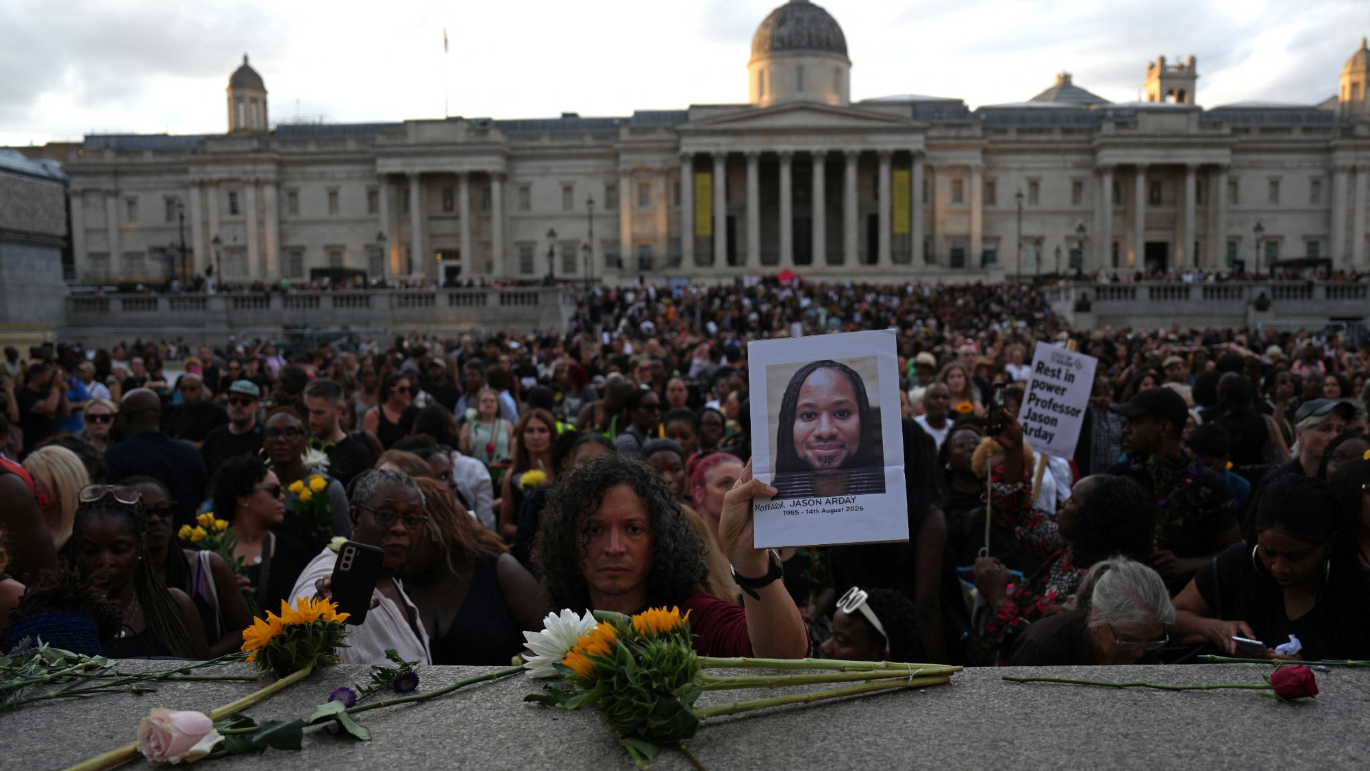 Supporters leave flowers and photographs at a vigil for late Cambridge professor Jason Arday in Trafalgar Square