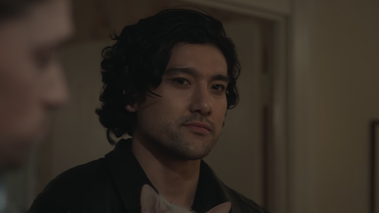 Will Sharpe holding a dog in episode 1 of Too Much