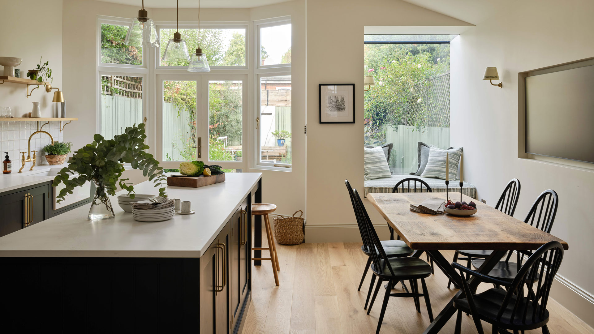 kitchen diner with kitchen island and wooden flooring