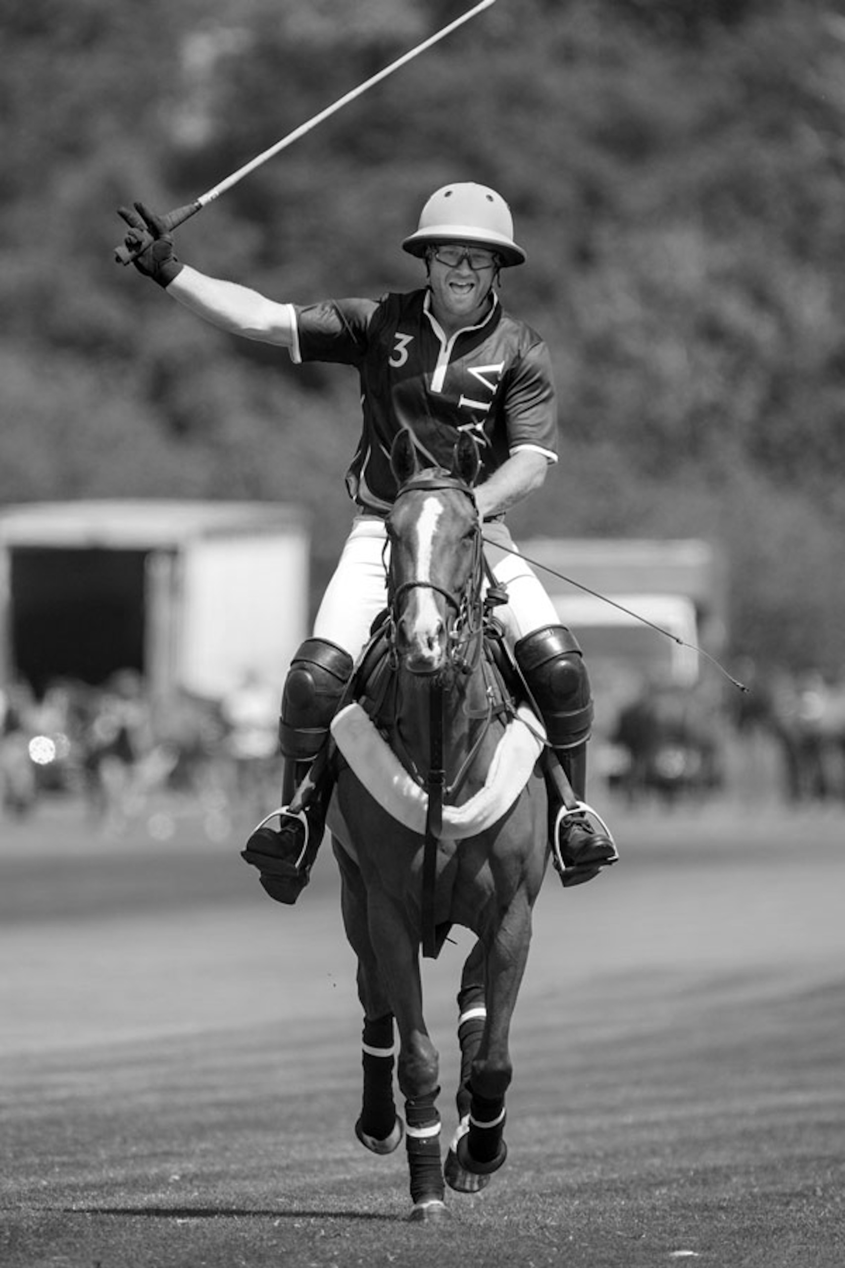 A black and white image of Harry Revell playing polo