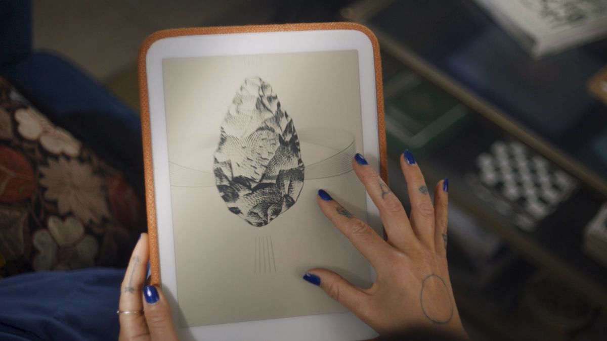 A hand holding the Daylight DC-1 tablet