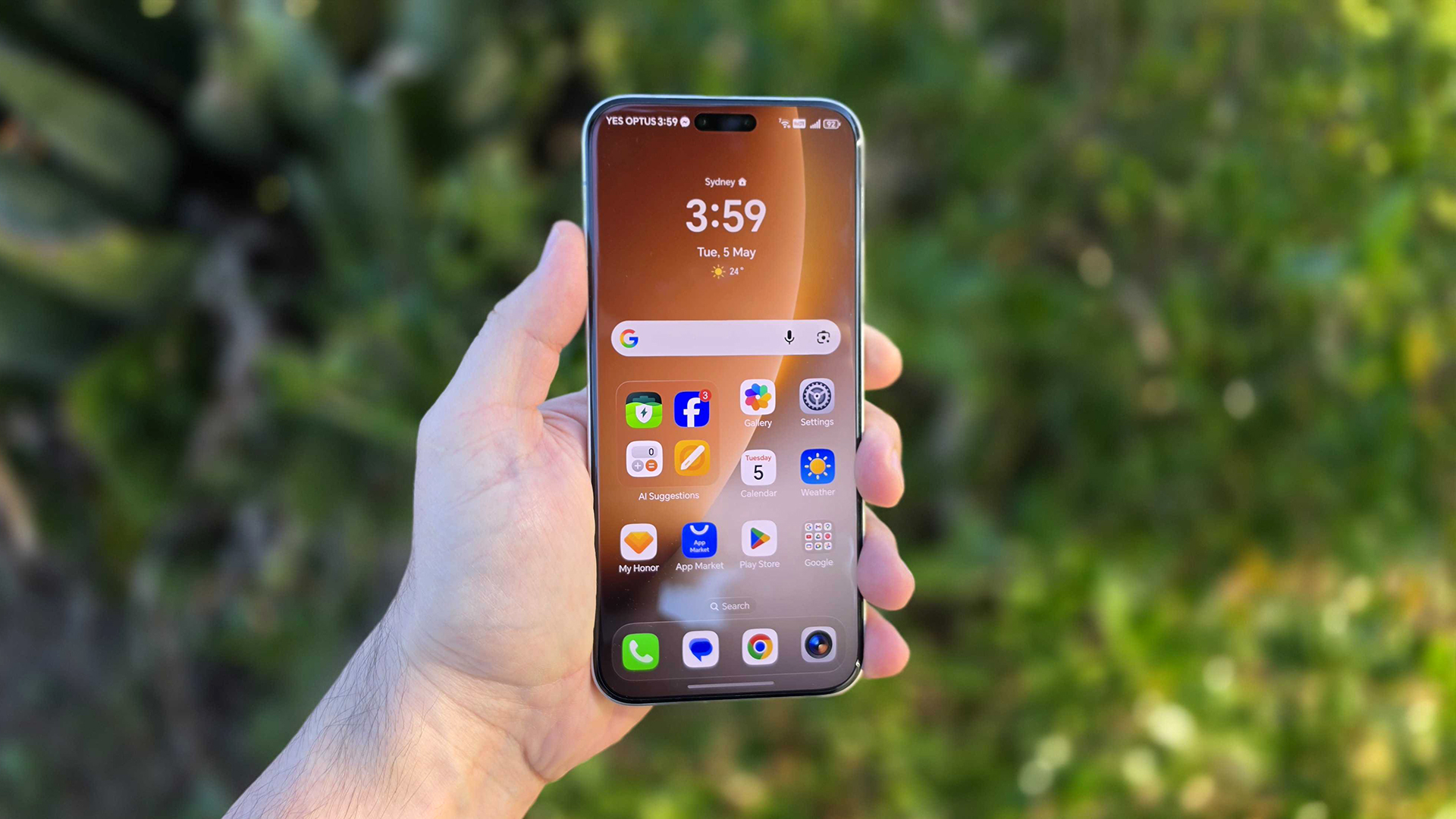 In-hand image of the Honor Magic8 Pro with garden background