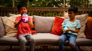 Two children playing with AlpenGlow lamps