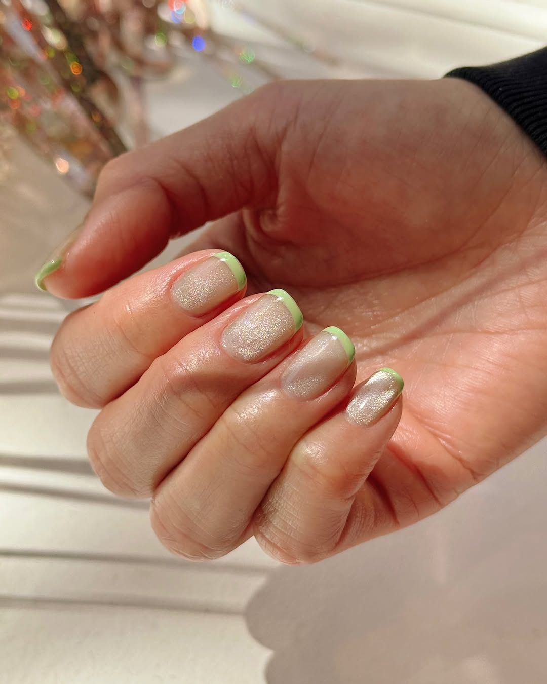 champagne and green cat eye french manicure