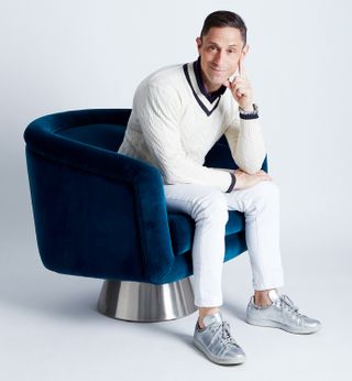 Jonathan Adler on a blue chair