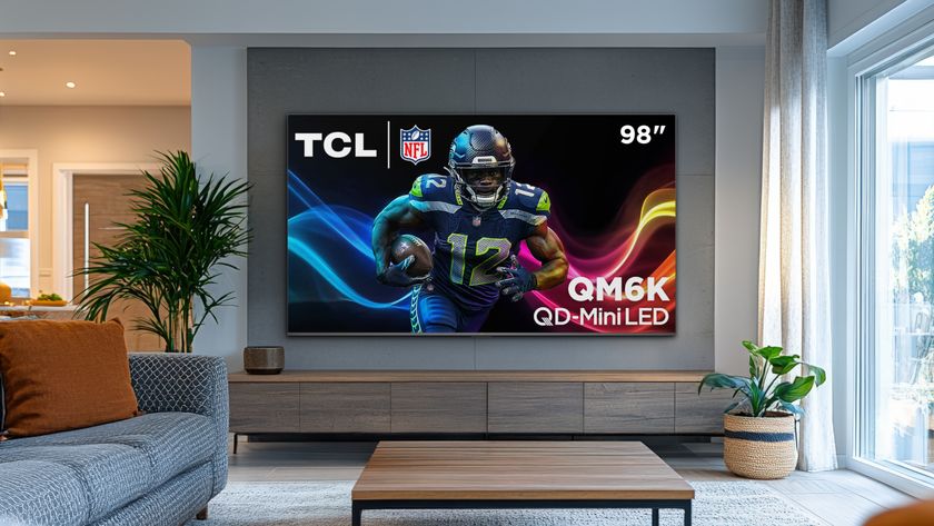 The 98-inch TCL QM6K in a modern living room displaying a professional NFL player