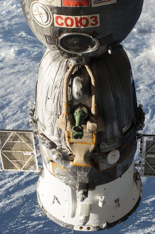 A Russian Soyuz spacecraft is seen docked to the International Space Station, as photographed by one of the Expedition 39 crew members aboard the orbital outpost.