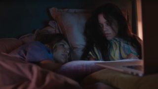 Maddie Ziegler and Jenna Ortega talking in bed in The Fallout.