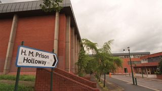 A sign points to the entrance of Holloway prison in London.