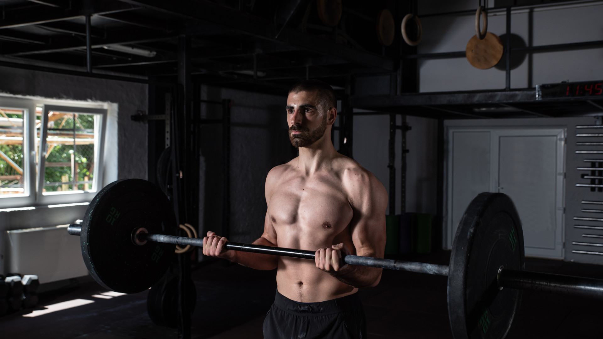 A man performing barbell bicep curls