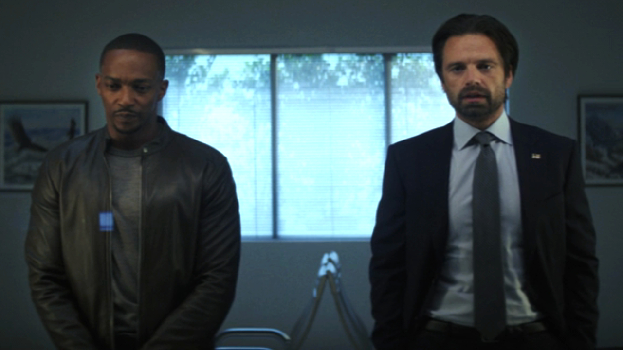 Anthony Mackie stands next to Sebastian Stan in a hospital waiting room in Captain America: Brave New World.