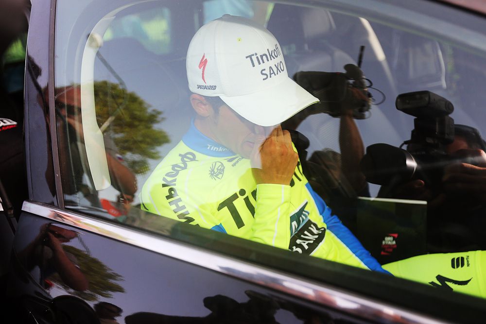 Contador sits in his team car after crashing near the finish of stage 6.