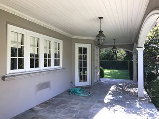 dated patio next to a house with grey walls