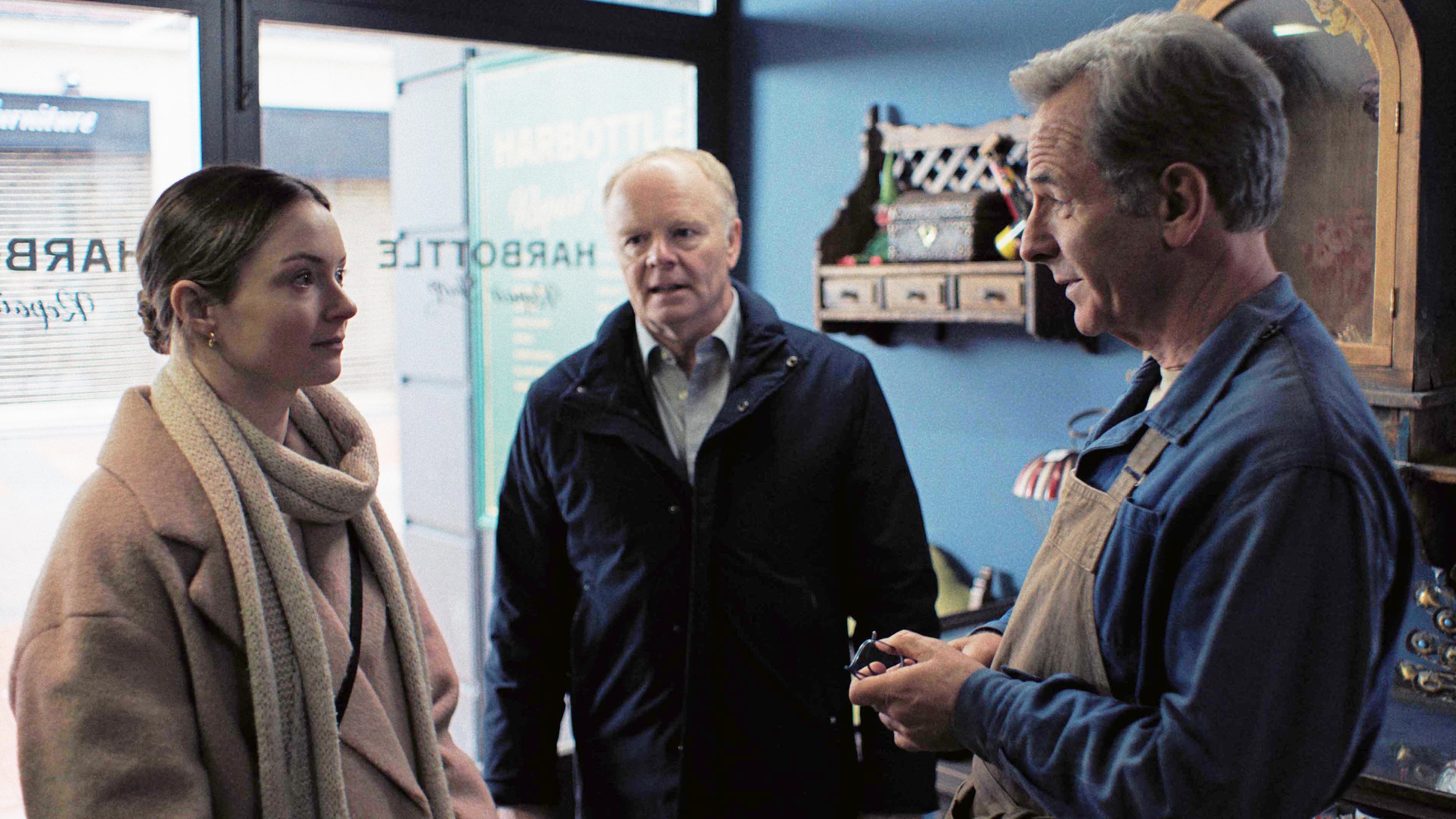 Huw watching on as he introduces Ruth to Patrick in his repair shop